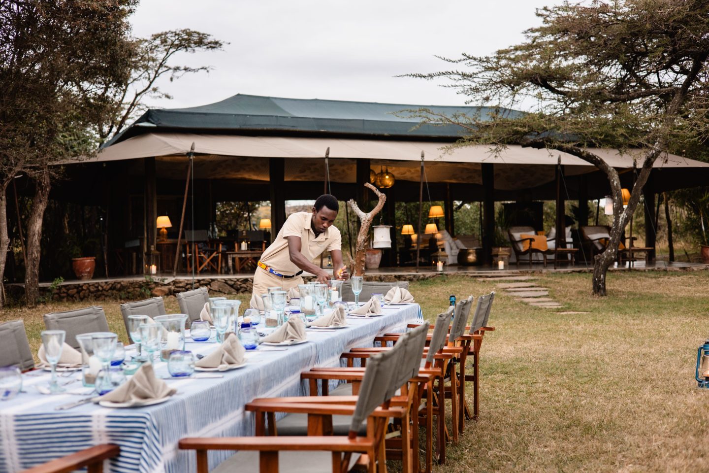 A long table laid for dinner beneath an open-sided canopy