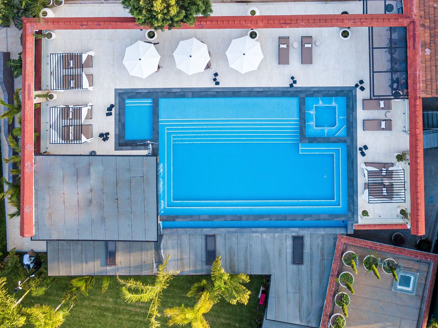 A rectangular pool and loungers photographed from directly above